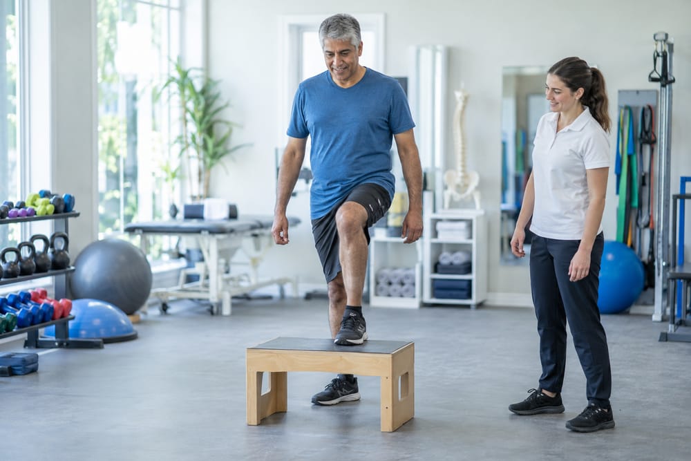Man doing a step-up exercise to strengthen his knee