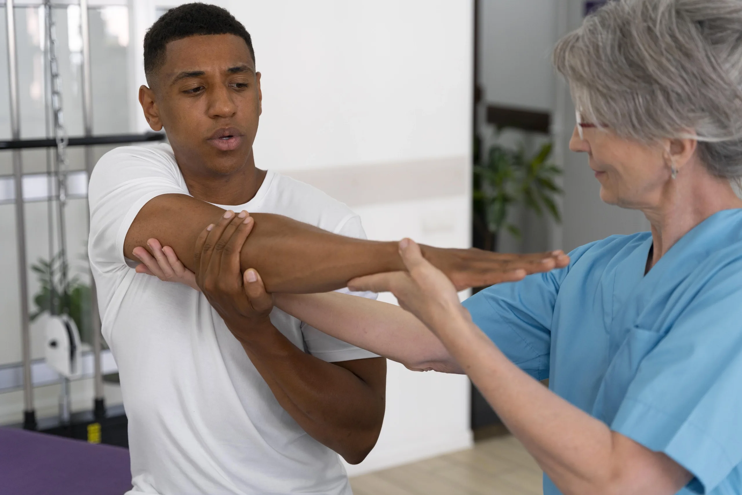 Clinician guiding a patient through a shoulder stretch