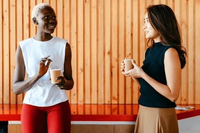 Two colleagues talking over coffee